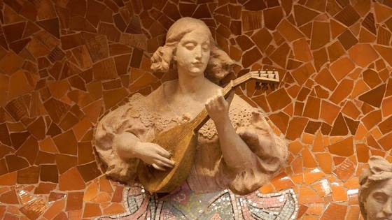 Close-up of a muse playing a mandolin